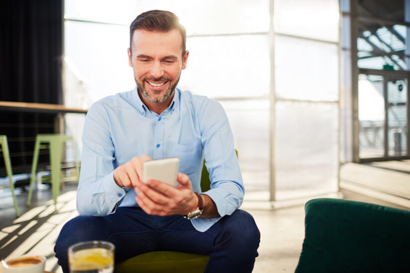 Man smiling at phone